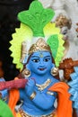 Indian handicraft statue of god Lord Krishna, many handmade colorful sculptures of Hindu god Royalty Free Stock Photo