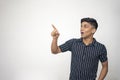 An indian handsome asian man wearing black shirt with white line and shocking expression on a white background