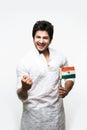 Indian handsome boy or man in white ethnic wear holding indian national flag and showing patriotism, standing isolated over white Royalty Free Stock Photo