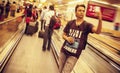 An Indian handsome man standing on escalator