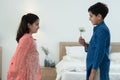 Indian handsome shy boy holding small white flower received surprise gift from little cute girl, children wear traditional Royalty Free Stock Photo