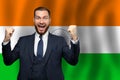 Indian happy businessman on the background of flag of India Business, education, degree and citizenship concept Royalty Free Stock Photo