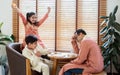 Indian happy family, father, son, daughter smiling, wearing traditional clothes, playing game in living room at home together with Royalty Free Stock Photo