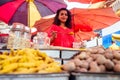 Indian happy woman salling spices in bazaar in Goa Royalty Free Stock Photo