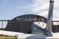 `Learn to Fly Here` banner on top of a tin rusty airport hangar in local Maryland Airport 2w5. Royalty Free Stock Photo