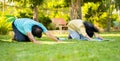 Indian healthy senior couple doing yoga or exercising by stretching at park - concept of healthy active lifestyle Royalty Free Stock Photo