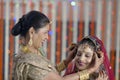 Indian Hindu Bride getting ready with help of moth