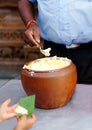 Indian Hindu distributing prasad butter to devotees to eat as blessed food by God During Krishnastami festival Royalty Free Stock Photo