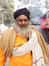 An Indian Hindu monk or sadhu baba in front of the Gangasagar Mela transit camp heading towards gangasagar mela.