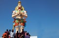 Indian Hindus on stairs of tall Hanuman statue to pray in temple on Mahasivaratri day
