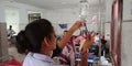 an indian hospital nurse injecting needle into the glucose bottle during treatment in india aug 2019 Royalty Free Stock Photo