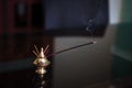 Indian incense sticks smoke in a Golden stand.