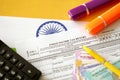 Indian income tax return blank form with pen and indian rupees bills