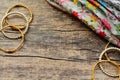 Indian jewelry bracelets and floral ethnic fabric lie on a wooden background