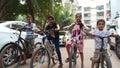 Indian kids ride cycle in colony