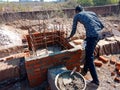 an indian labour fixing wall from cement material and bricks in India dec 2019