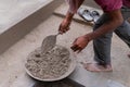 Indian labour mixing cement by hand
