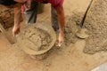 Indian labour mixing cement using shovel