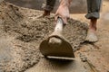 Indian labour mixing cement using shovel