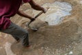 Indian labour mixing cement using shovel