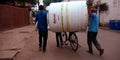 indian labour transporting water tank supreme with bicycle in india oct 2019 Royalty Free Stock Photo