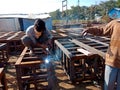 an indian labour welding on iron structure during indian railway bridge construction in india January 2020