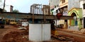 an indian labour working for road construction work seating upon cement piller in India aug 2019