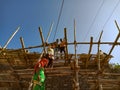 indian labours making wooden structure for wall plaster work on site in India January 2020