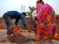 indian labours mixing raw material at construction site in India December 2019