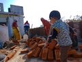 an indian little boy picking brick on construction site in India January 2020 Royalty Free Stock Photo