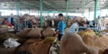 An indian little boy holded wheat sack at wholesale godown