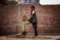 Indian little girl on hand-pump