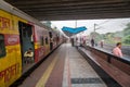 Indian local passenger train about to leave a railway station on a foggy winter morning.