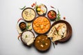 Indian lunch or dinner items like dal, paneer butter masala, roti, rice, salad