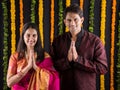 Indian maharashtrian young couple in traditional wear in namaskara pose