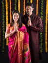 Indian maharashtrian young couple in traditional wear in namaskara pose