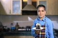 Indian Male Chef with a sweet dish in kitchen interiors Royalty Free Stock Photo