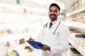 Indian male doctor with clipboard and stethoscope Royalty Free Stock Photo