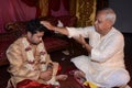 Indian Male giving blessings to his daughter-in-law during wedding