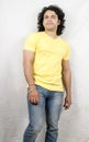 Indian male model wearing yellow tshirt and blue jeans Royalty Free Stock Photo