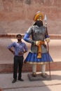 Indian Male standing with a statchu of a great RAJA of jaipur.