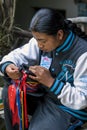 An Indian man attaches ribbons to a hat in a factory in the town of Puguche in Ecuador.