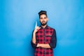 Indian man with beard raising index finger up while having brilliant idea isolated on blue background Royalty Free Stock Photo