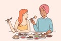 Indian man and caucasian woman are sitting at dinner table tasting traditional Indian cuisine Royalty Free Stock Photo