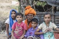 Indian man with children in the desert on time Pushkar Camel Mela near holy city Pushkar, Rajasthan, India Royalty Free Stock Photo