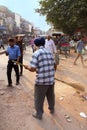 Indian man cleaning street after Guru Nanak Gurpurab celebration