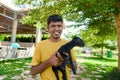 Indian man Cradles Young Black Goat on Sunny Farm Royalty Free Stock Photo