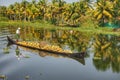 Indian man delivers coconuts by boat.