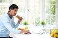 Indian Man Enjoying Breakfast At Home Royalty Free Stock Photo