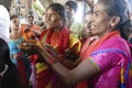 Indian man gives laddu treats to pilgrims